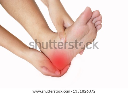 Woman she pain in the heel. Massage of female feet. Isolated on white background