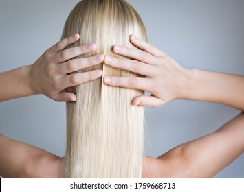 A Woman With Shinny Smooth Blonde Hair. Hair Care.