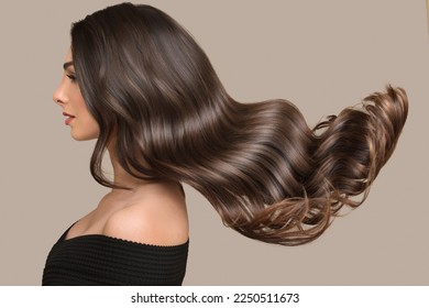 woman shiny long wavy hair up. side view. grey background - Shutterstock ID 2250511673