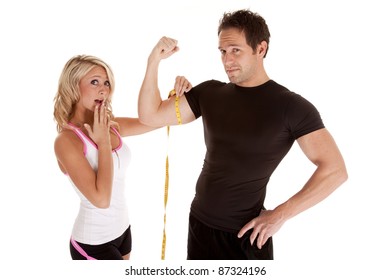 A woman is shocked at how big her man's muscles are.