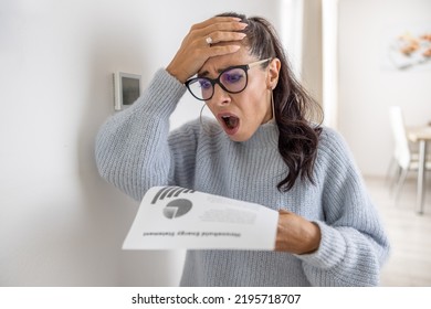 Woman is shocked from the rising energy costs and the bill she received for heat and electricity for her household. - Shutterstock ID 2195718707