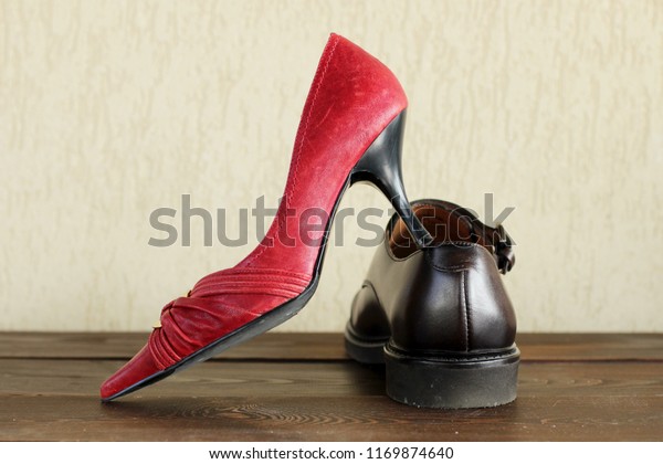 Woman shoes against men shoes, man vs woman\
concept, feminist and mens\
world.