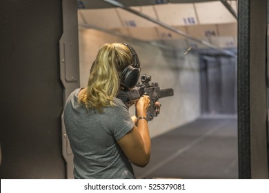 Woman Shooting At Firing Range. 
