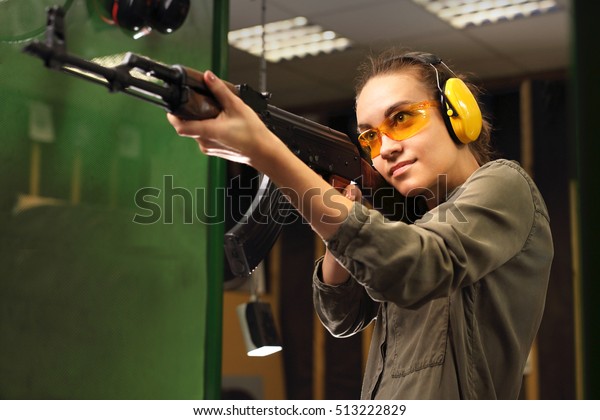 The woman\
at the shooting range shot from a\
rifle.