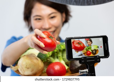 A Woman Shooting Video With A Smartphone.