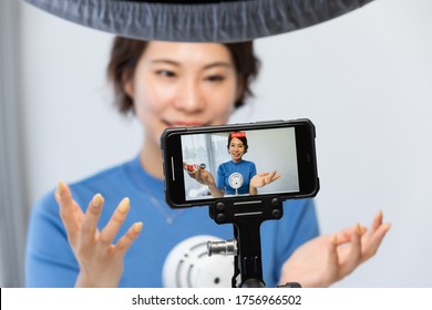 A Woman Shooting Video With A Smartphone.