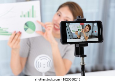 A Woman Shooting Video With A Smartphone.