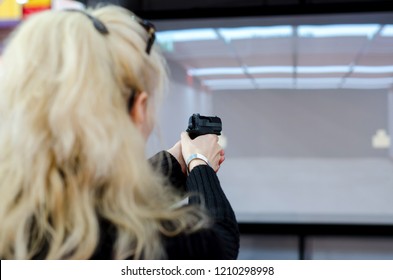 Woman shooting in virtual shooting gallery