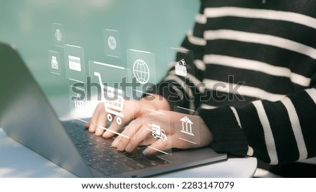 Woman or Shopper using a laptop computer with shopping cart and business icon, Online shopping and e-commerce technology internet concept, shopping service on the online web and offers home delivery.