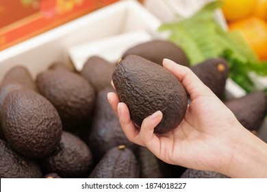 Woman Shopping For Avocado In Supermarkets