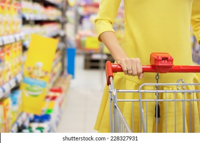 Woman Shopping For Baby Food In Supermarket