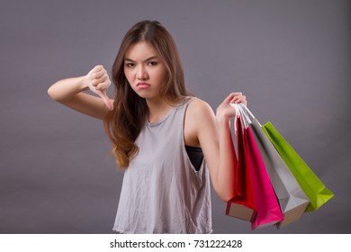 Woman Shopping With Shopping Bag And Thumb Down Hand Sign, Bad Shopping Experience Concept
