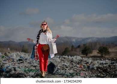 Woman With Shopping Bags On Landfill, Consumerism Versus Pollution Concept.