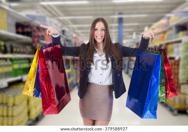 woman with shopping\
bags at the supermarket