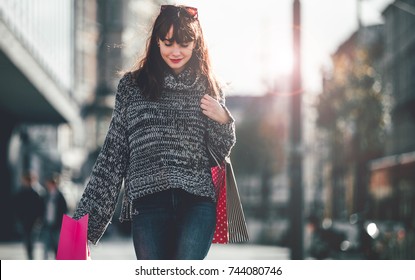 Woman With Shopping Bags Walking On The Street, City Scene