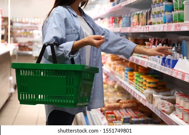 Woman With Shopping Basket In Supermarket, Closeup