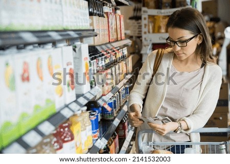 Woman shopping with coupons in market