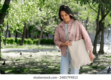 Woman shopping with fabric tote bag outside - Powered by Shutterstock