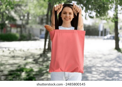 Woman shopping with fabric tote bag outside