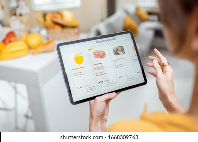 Woman Shopping Food Online Using A Digital Tablet At The Kitchen, Close-up View On A Tablet Screen. Concept Of Buying Online Using Mobile Devices