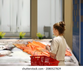 Woman Shopping For Fresh Fish Seafood In Supermarket 