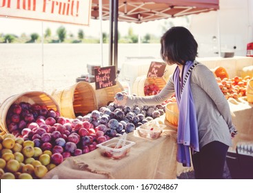 Woman Shopping For Fruit At An Outdoor Market