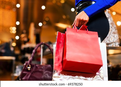 woman in a shopping mall with colorful bags