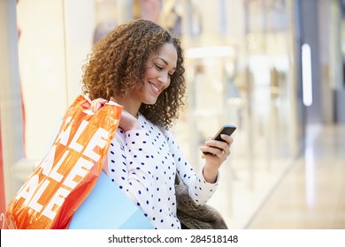 Woman In Shopping Mall Using Mobile Phone