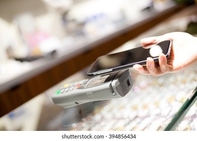 Woman Shopping With Mobile Phone Payment