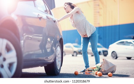 Woman With Shopping Near Car