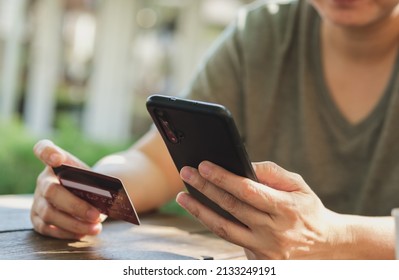 Woman Shopping Online With Credit Card At Coffee Shop In Outdoor.close Up Hand Holding Smartphone