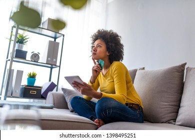 Woman shopping online with laptop at home in the living room. Woman shopping online. Happy Woman shopping online with credit card and tablet computer.Internet Shopping