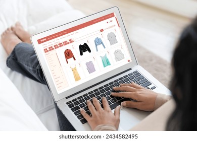 Woman shopping online on internet marketplace browsing for sale items for modern lifestyle and use credit card for online payment from wallet protected by crucial cyber security software - Powered by Shutterstock