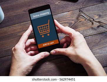 A woman is shopping at the online store. Shopping cart icon. Ecommerce.