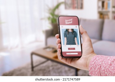 Woman Shopping Online Using Second Hand Sale App On Her Smartphone, Room Interior In The Background, POV Shot