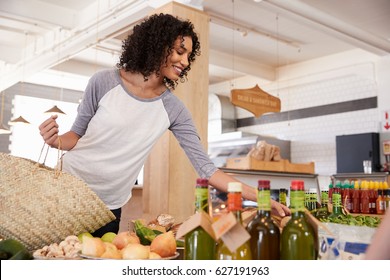 Woman Shopping For Organic Produce In Delicatessen