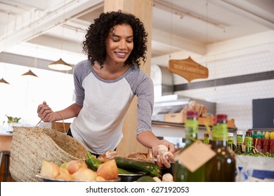 Woman Shopping For Organic Produce In Delicatessen