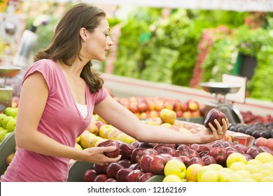 Woman Shopping In Produce Department Of Supermarket