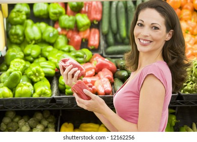 Woman Shopping In Produce Section Of Supermarket