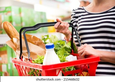 Woman Shopping At Store With Shopping Basket.