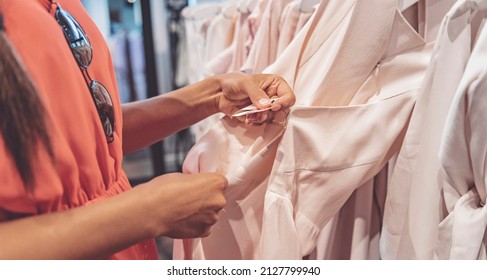 Woman Shopping In Store Looking At Price Tag Of Expensive Dress Clothing. Inflation Affecting Cost And Purchase Power. Banner Background.