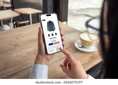 Woman shops for men's blazer on smartphone. Modern ecommerce app interface concept for effortless browsing and purchasing of stylish clothing