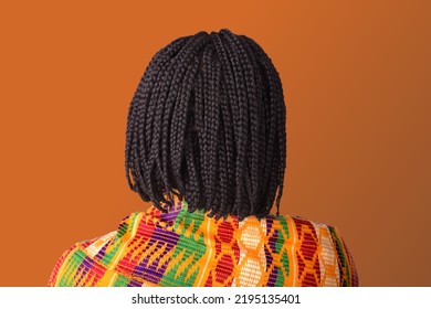 Woman With Short Braided Hair And Kente Wrap On Orange Background