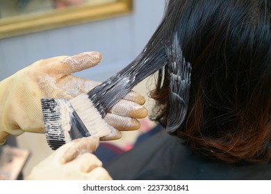 A woman with short hair dyes her hair. - Powered by Shutterstock