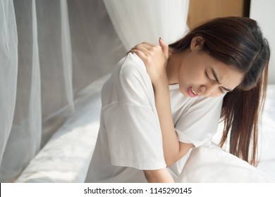 Woman With Shoulder Or Neck Pain; Portrait Of Asian Woman Suffering From Shoulder Or Neck Pain, Stiffness, Injury, Chronic Bone Or Muscle Injury, Body And Health Care Concept; Asian Adult Woman Mode