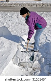 Woman Shoveling Snow