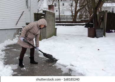 Woman shoveling snow off