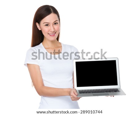 Woman show with the empty screen of notebook computer