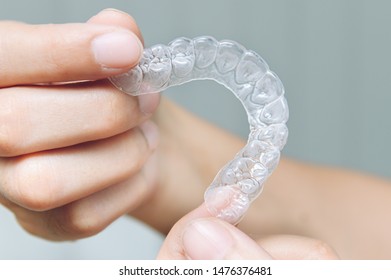 Woman show orthodontic silicone trainer. Mobile orthodontic appliance for dental correction. tooth whitening systems. - Shutterstock ID 1476376481