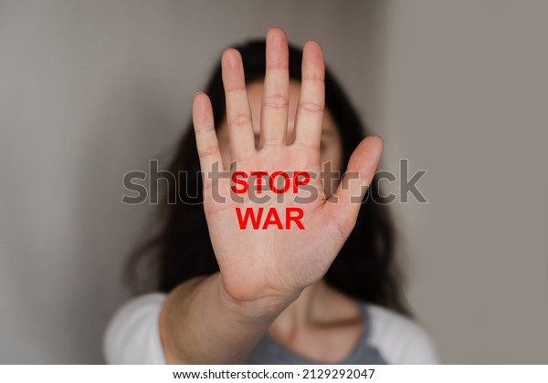 Woman show stop war in Ukraine with text. Russia\
stop war. Putin invasion